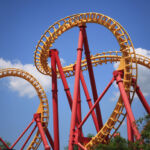 A Colorful Looping Roller Coaster On A Beautiful Sunny Day