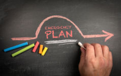 Emergency Plan. Colored chalk pieces on a dark chalkboard background.