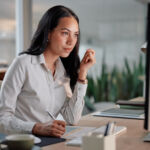 Congress and accredited investors Business, thinking and woman with computer, writing and inspiration with online news and reading a financial blog. Accountant, planning and broker with a pc and notebook with deadline for a project