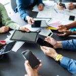 Hands with mobiles and digital tablets% sharing energy, information. Business technology concept.