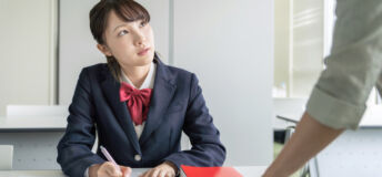 New DOE exam letter–AML Asian female high school student and teacher in classroom. Cram school. Preparatory school. Home tutor.