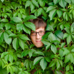 A young man among the thickets of ivy.