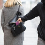 Close-up Of A Person Stealing Purse From Handbag