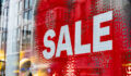 Large Sale sign in white and red in a retail shop window
