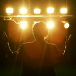 Female politician speaks to audiences under spotlights