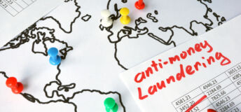 Anti-money laundering (AML) concept. Data and thumb tacks in a map.