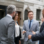 Successful group of business people talking on the street