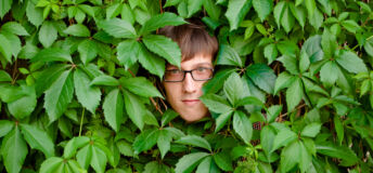 A young man among the thickets of ivy.