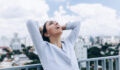 Young Brazilian business woman relieved after work.