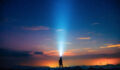 A person holding a flashlight under the starry sky