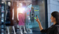 Advertising P&P smart retail, shopping online technology concept, woman try to use smart display with virtual or augmented reality in the shop or retail to choose select ,buy cloths and give a rating of products