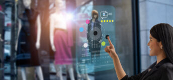 Advertising P&P smart retail, shopping online technology concept, woman try to use smart display with virtual or augmented reality in the shop or retail to choose select ,buy cloths and give a rating of products