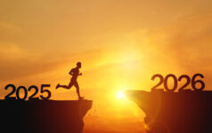 New Year 2026, Inspiration and progress towards new success. Silhouettes of human jumping over cliff towards finish line with text new year 2026 on sunset beautiful
