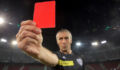 Portrait of referee showing red card during football match.