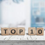 Top 10 sign made of wooden dices on a table i a bright environment with blue colors