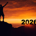 Man silhouette on the mountain top watching the sunrise of the new year 2026 , Highlighting New Year Dreams and New Goals