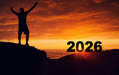 Man silhouette on the mountain top watching the sunrise of the new year 2026 , Highlighting New Year Dreams and New Goals