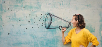 Young woman holding an imaginary megaphone and shouting into it