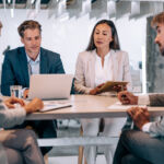 Group of business persons in business meeting. Multi-ethnic group of entrepreneurs on meeting in board room. Corporate business team on meeting in modern office.