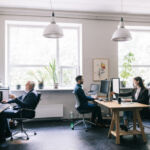 Modern office setup featuring professionals working collaboratively and individually in a creative environment.