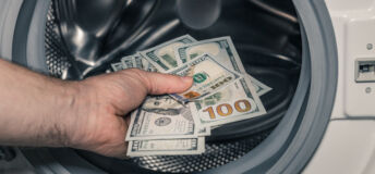 American dollars being put into the washing machine, Concept, Money laundering, Illegal business proceeds, Dark business, Black market, Bundle of 100 dollar bills