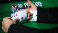 Man with ace up his sleeve, cheating at poker.