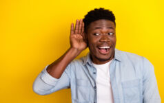 Photo of positive guy interested incredible discount message look empty space hear isolated vibrant color background.