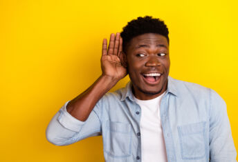 Photo of positive guy interested incredible discount message look empty space hear isolated vibrant color background.