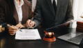 business people and lawyers discussing contract papers sitting at the table. Concepts of law, advice, legal services.