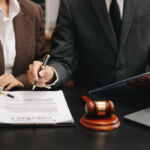 business people and lawyers discussing contract papers sitting at the table. Concepts of law, advice, legal services.