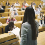 Students sitting in amphitheater and studying