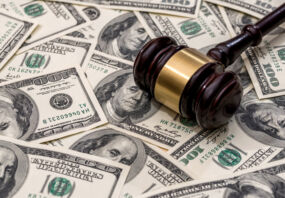 wooden hammer on dollar. close up