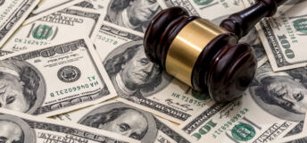 wooden hammer on dollar. close up