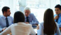 Business people having meeting, elderly CEO leading the discussion