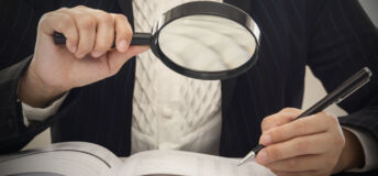 Corruption audit concept. Inspector using magnifying glass for inspect budget corruption