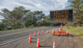 SECOND CHANCE AHEAD: This is a photograph of a mobile roadside sign parked on highway one in northern California. It is a trailer and powered by batteries and provides information and warnings for drivers by displaying words on a large panel display.