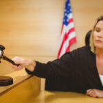 Judge about to bang gavel on sounding block in the court room