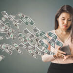 SEC notice on performance-based fees unhappy and poor Asian woman holding purse having problem with money flying away, over spending concept background