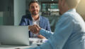 Shot of two businessmen shaking hands in an office