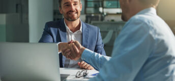 Shot of two businessmen shaking hands in an office