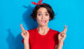 Photo of sad young brunette lady bite lip wear red t-shirt hairband isolated on blue color background.