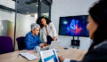 Coworkers collaborating on AI project during business meeting in office