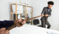 Two Businessmen Pulling Rope In Opposite Direction