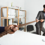 Two Businessmen Pulling Rope In Opposite Direction