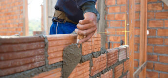 Build Your AI Policy in 1 Day Worker building masonry house wall with bricks