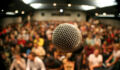 A mic in front of a packed theater.