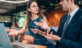 Businessman and business woman have lively discussion in modern office