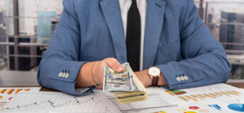 male businessman in a super suit and tie makes payments to the business at the table. Business and money concept