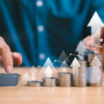 Money interest rate increase concept, percentage commission credit. Grow up stock risk management. Bank policy price raise. Businessman with coin, calculate high percentage of company profit dividend