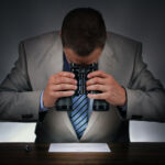 Businessman studying a contract to sign closely with binoculars concept for checking the small print
